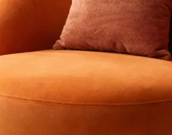 Close crop of the Contour Comfort chair's seat showing a smooth napped surface with directional light shading and no visible looped texture