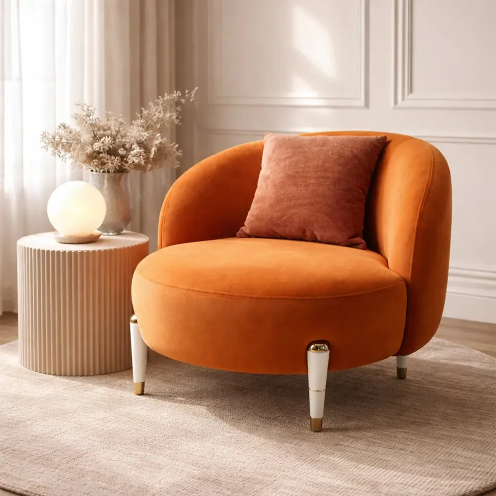 The Contour Comfort chair styled beside a fluted side table with a globe lamp and dried grasses